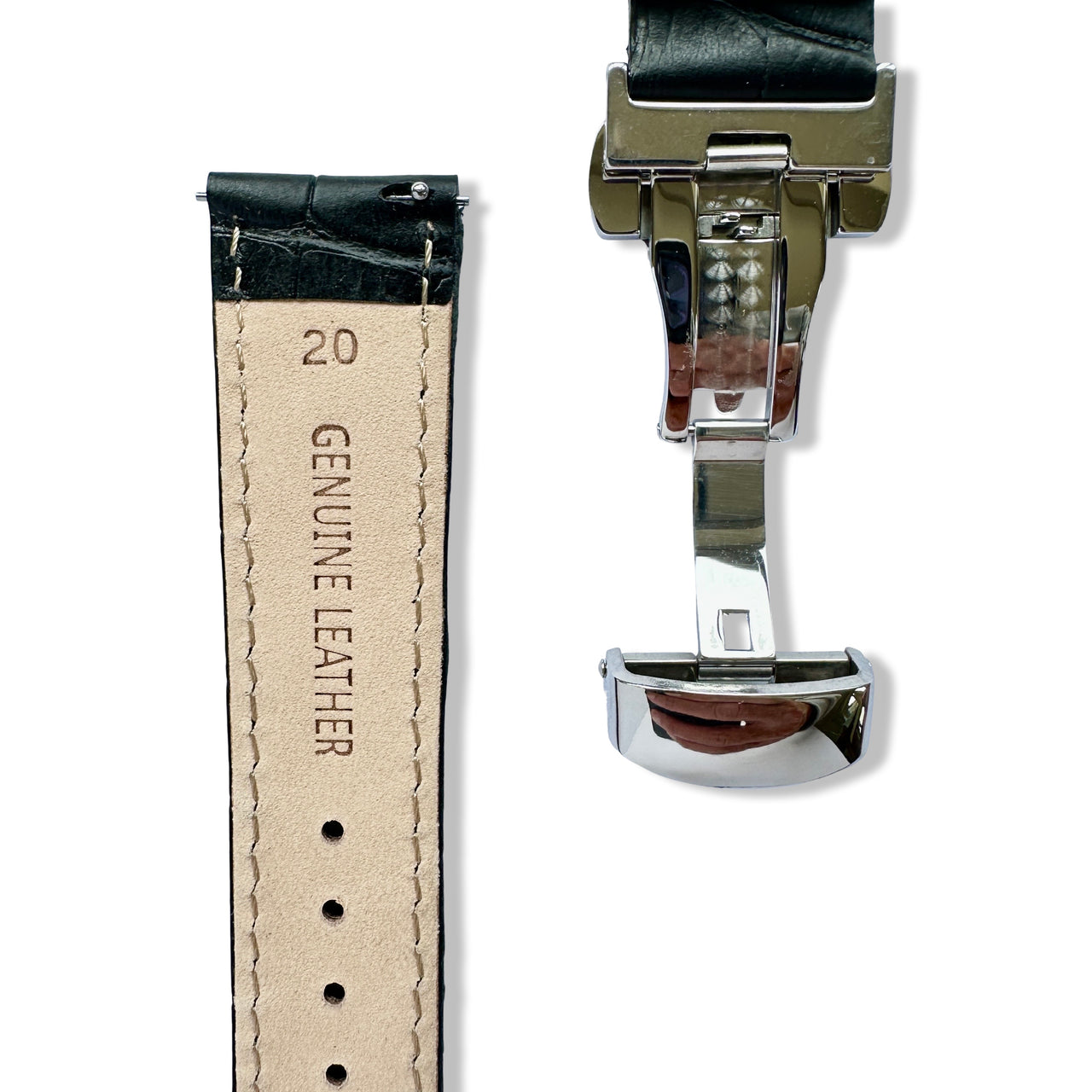 Close-up of a watch strap with leather texture and metal clasp on a white background