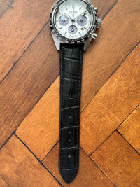 Thumbnail for Watch with a black strap on a wooden surface