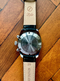Thumbnail for Watch with a leather strap on a wooden surface