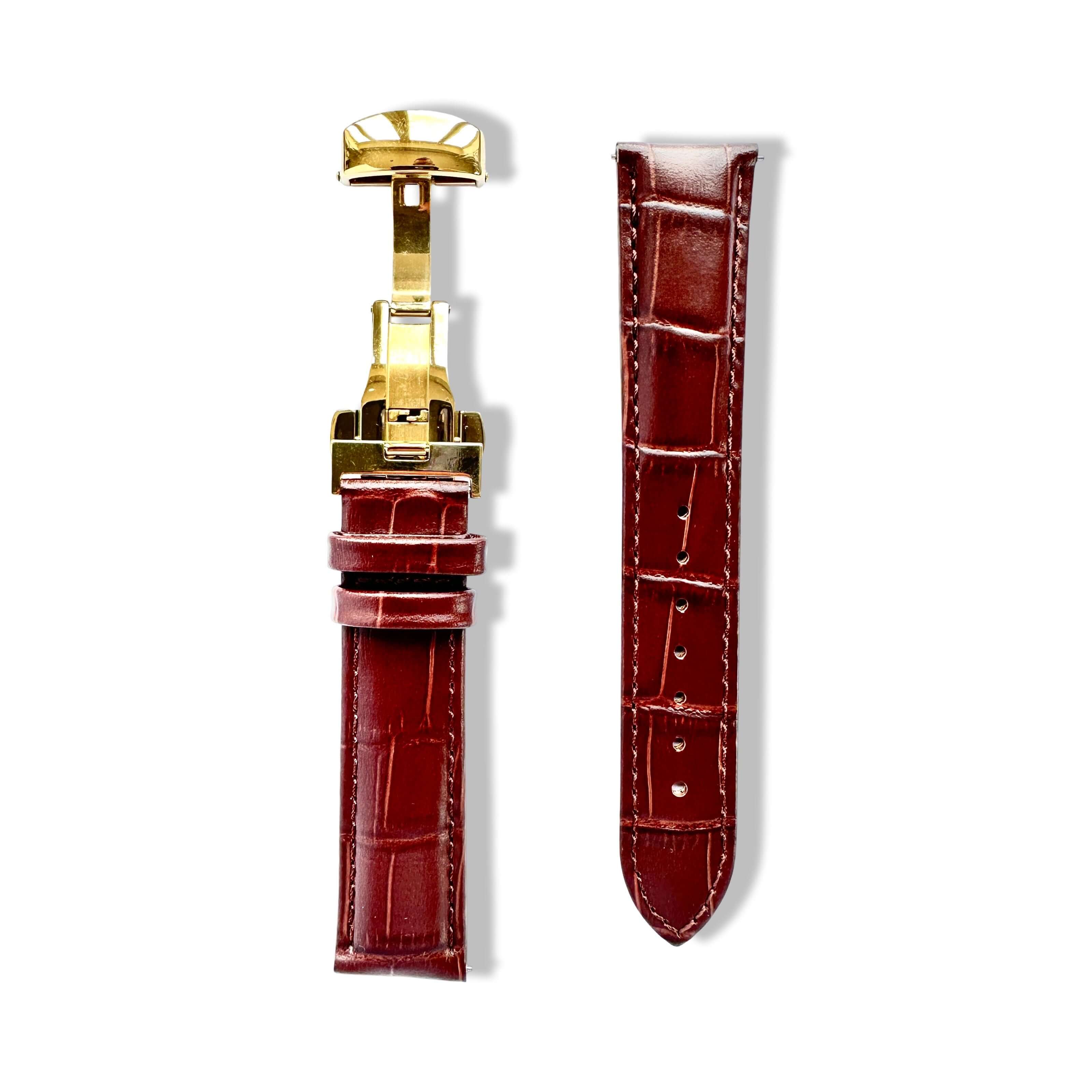 Brown crocodile-patterned watch strap with gold buckle on a white background
